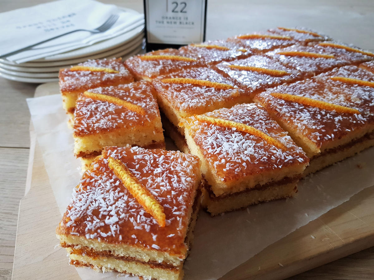 vierkante stukjes gestapelde sinaasappelcake met een laagje lemoncurd